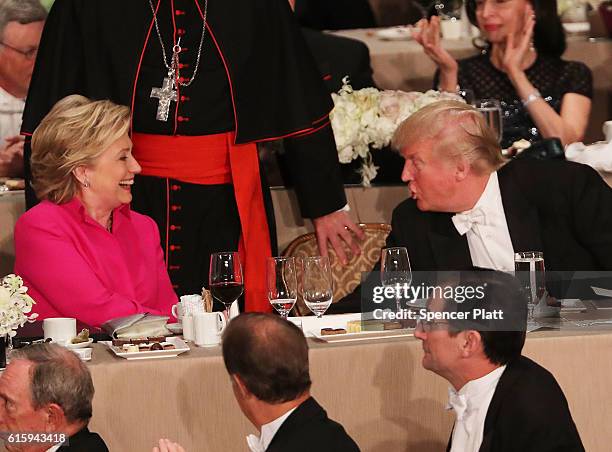 Hillary Clinton speaks briefly with Donald Trump while attending the annual Alfred E. Smith Memorial Foundation Dinner at the Waldorf Astoria on...