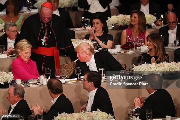 Hillary Clinton speaks briefly with Donald Trump while attending the annual Alfred E. Smith Memorial Foundation Dinner at the Waldorf Astoria on...