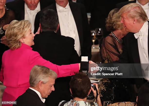 Hillary Clinton shakes hands with Donald Trump while attending the annual Alfred E. Smith Memorial Foundation Dinner at the Waldorf Astoria on...