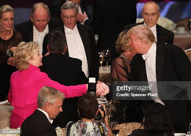 Hillary Clinton shakes hands with Donald Trump while attending the annual Alfred E. Smith Memorial Foundation Dinner at the Waldorf Astoria on...