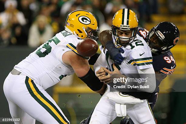 Quarterback Aaron Rodgers of the Green Bay Packers fumbles the ball for outside linebacker Leonard Floyd of the Chicago Bears to recover the ball for...