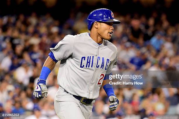 Addison Russell of the Chicago Cubs hits a two-run home run in the sixth inning against the Los Angeles Dodgers in game five of the National League...