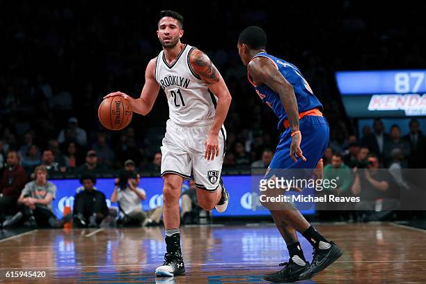 Greivis Vasquez of the Brooklyn Nets dribbles up the court against Brandon Jennings of the New York Knicks during the first half of their preseason...