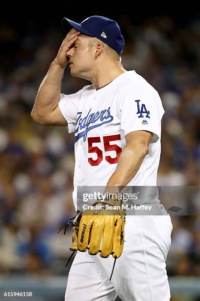 Joe Blanton of the Los Angeles Dodgers reacts after Addison Russell of the Chicago Cubs hits a homerun in the sixth inning in game five of the...