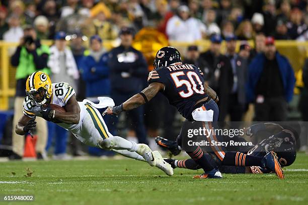 Wide receiver Ty Montgomery of the Green Bay Packers carries the ball against inside linebacker Jerrell Freeman of the Chicago Bears in the third...