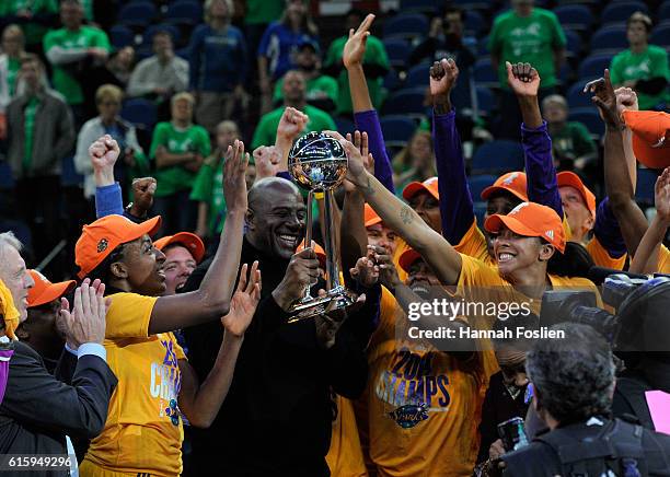 Owner Magic Johnson of the Los Angeles Sparks holds the Championship Trophy for his team after a win in Game Five of the 2016 WNBA Finals against the...
