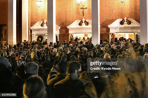 United States - People gather at St. Rose of Lima Church in Newtown, Connecticut, on Dec. 14 to attend a mass to mourn for the victims of a mass...