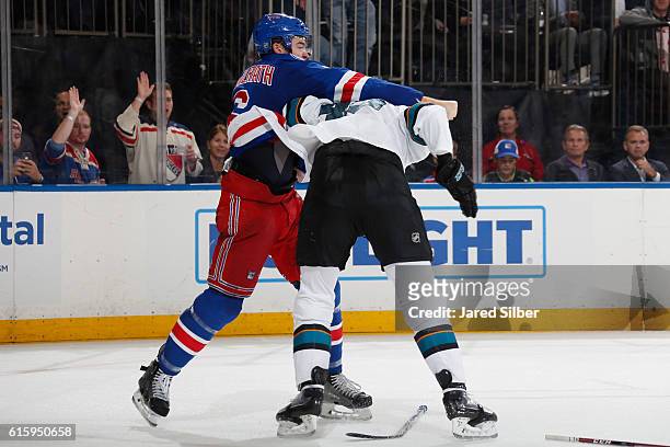Dylan McIlrath of the New York Rangers and Tomas Hertl of the San Jose Sharks fight during the second period at Madison Square Garden on October 17,...