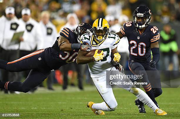 Wide receiver Davante Adams of the Green Bay Packers is tackled by inside linebacker Jerrell Freeman of the Chicago Bears in the fourth quarter at...