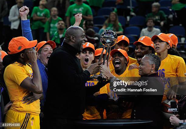 President Lisa Borders hands the Championship Trophy to Magic Johnson, owner of the Los Angeles Sparks after a win in Game Five of the 2016 WNBA...