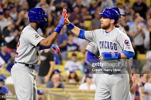 Jason Heyward and Ben Zobrist of the Chicago Cubs celebrate after a three-run double in the eighth inning against the Los Angeles Dodgers in game...