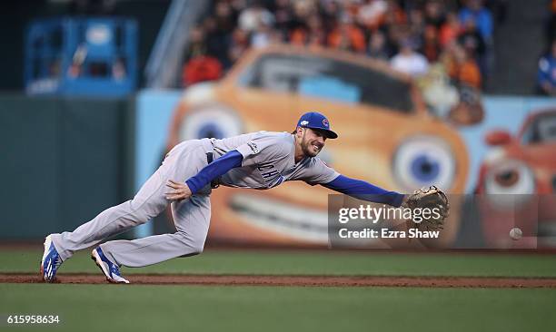 Kris Bryant of the Chicago Cubs dives for a ball during their game against the San Francisco Giants in Game Four of the National League Division...