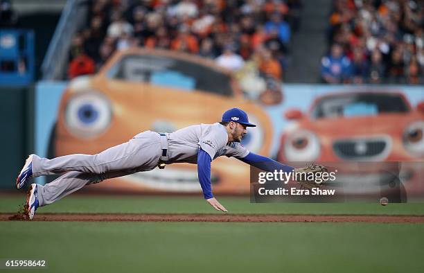 Kris Bryant of the Chicago Cubs dives for a ball during their game against the San Francisco Giants in Game Four of the National League Division...