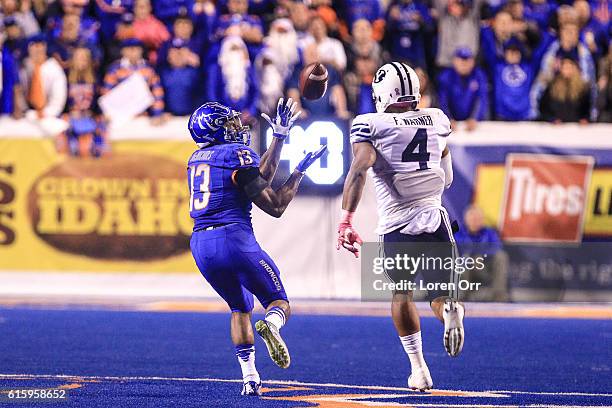 Running back Jeremy McNichols of the Boise State Broncos catches a 76 yard touchdown pass over the defense of linebacker Fred Warner of the Brigham...