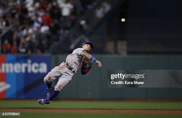 Javier Baez of the Chicago Cubs throws to first base against the San Francisco Giants during Game Four of the National League Division Series at AT&T...