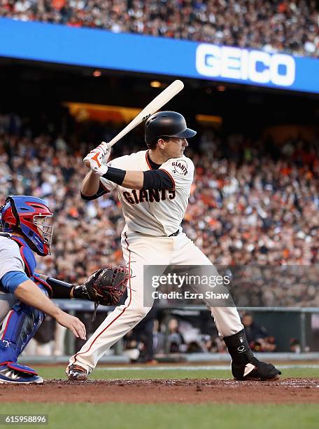 Buster Posey of the San Francisco Giants bats against the Chicago Cubs during Game Four of the National League Division Series at AT&T Park on...