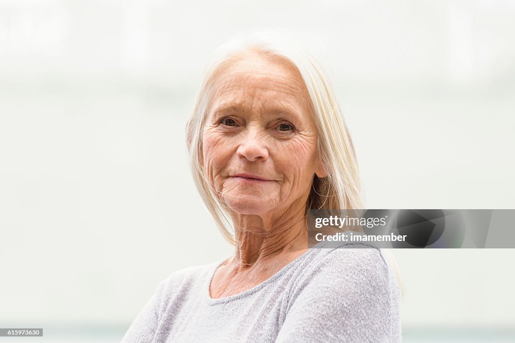 Portrait of modern attractive blond mature woman, copy space