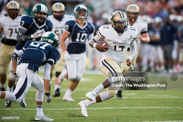 Westfield quarterback Rehman Johnson breaks through the defense in second quarter action against South County at South County Secondary School on...