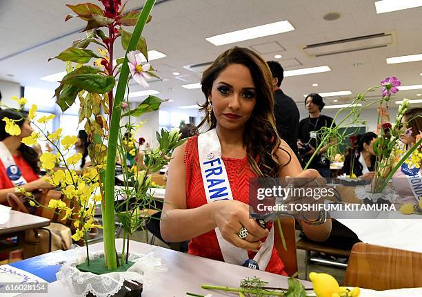 Miss France Khaoula Najine creates her Japanese trational flower arrangement at the Ikenobo headquarters in Tokyo on October 21, 2016. Seventy women...