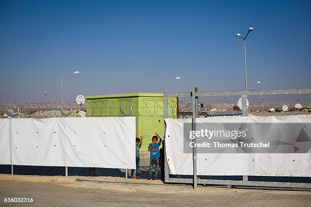 Nizip, Turkey Two Syrian refugee children stand behind a fence in an AFAD refugee camp on October 07, 2016 in Nizip, Turkey.