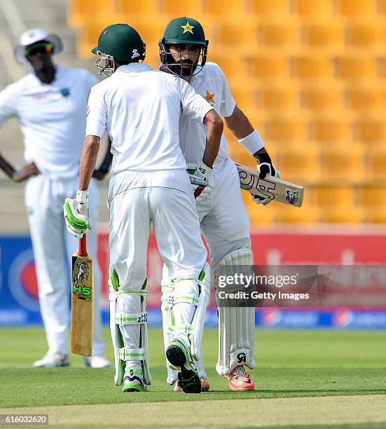 Misbah Ul Haq congratulates Younis Khan on his half century during Day One of the Second Test between Pakistan and the West Indies at the Zayed...