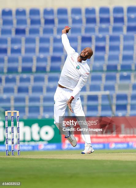 Roston Chase bowls during Day One of the Second Test between Pakistan and the West Indies at the Zayed Cricket Stadium on October 21, 2016 in Abu...
