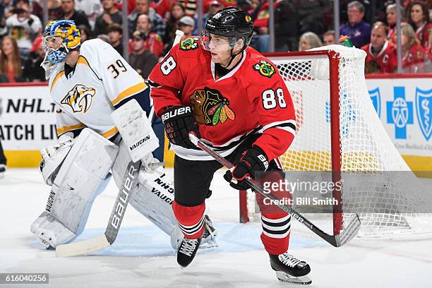 Patrick Kane of the Chicago Blackhawks looks up the ice next to goalie Marek Mazanec of the Nashville Predators in the first period at the United...
