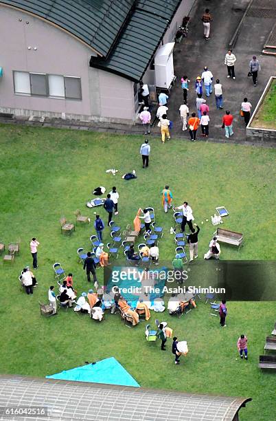 Residents of a nursing home evacuate at a field after the magnitude 6.6 earthquake hit the area on October 21, 2016 in Kurayoshi, Tottori, Japan. A...