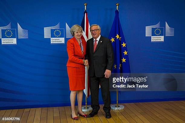 British Prime Minister Theresa May shakes hands with President of the European Commission Jean-Claude Juncker at the European Commission at the end...