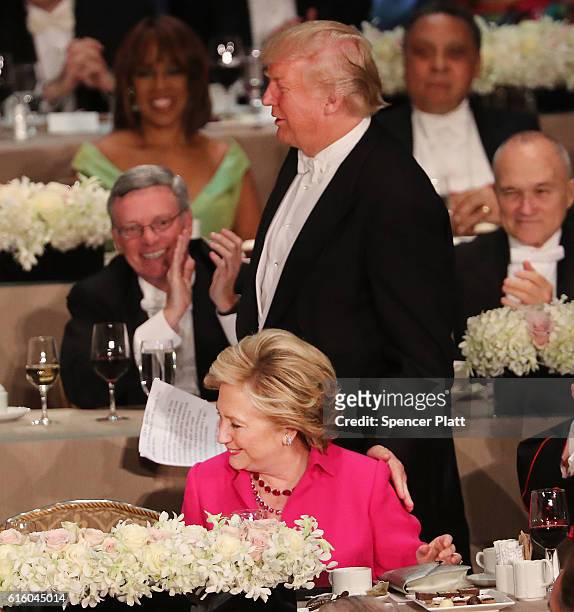 Donald Trump touches Hillary Clinton on the shoulder as he walks to the podium at the annual Alfred E. Smith Memorial Foundation Dinner at the...