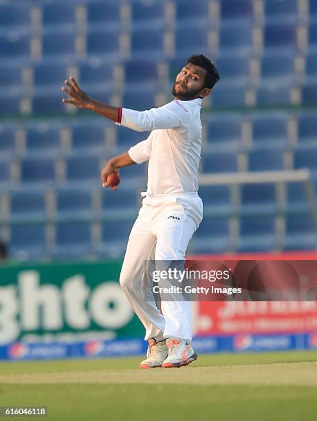 Devendra Bishoo bowls during Day One of the Second Test between Pakistan and the West Indies at the Zayed Cricket Stadium on October 21, 2016 in Abu...