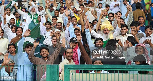 Pakistan supporters celebrate during Day One of the Second Test between Pakistan and the West Indies at the Zayed Cricket Stadium on October 21, 2016...
