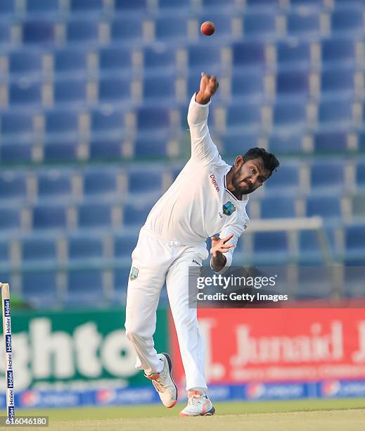 Devendra Bishoo bowls during Day One of the Second Test between Pakistan and the West Indies at the Zayed Cricket Stadium on October 21, 2016 in Abu...