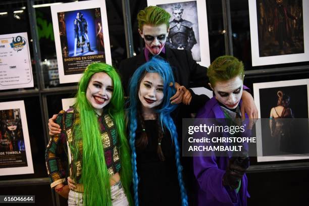 Visitors dressed up as comic characters pose during the Comic Con convention at the Grande Halle de la Villette, on October 21 in Paris.