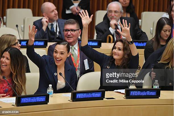 Actors Gal Gadot and Lynda Carter wave to the audience at the Wonder Woman UN Ambassador Ceremony at United Nations on October 21, 2016 in New York...