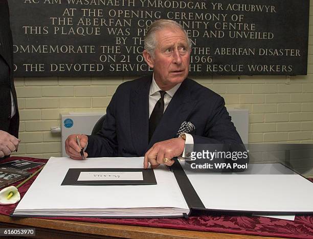 Prince Charles, Prince of Wales signs a book of condolence in memory of the 50th Anniversary of the Aberfan disaster, at the Aberfan and Merthyr Vale...