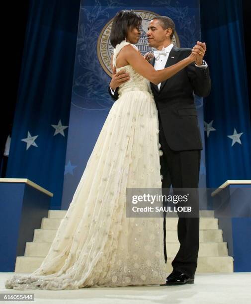 President Barack Obama and First Lady Michelle Obama dance during the Southern Regional Inaugural Ball at the DC Armory in Washington, DC, early...