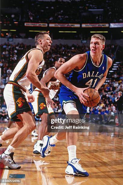 Dirk Nowitki of the Dallas Mavericks shoots against Detlef Schrempf of the Seattle SuperSonics during a game played on February 5, 1999 at Key Arena...