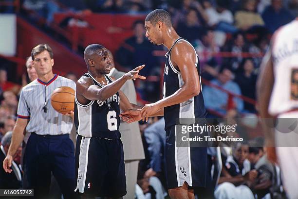Tim Duncan of the San Antonio Spurs talks with Avery Johnson against the Denver Nuggets on October 31, 1997 at McNichols Arena in Denver, Colorado....
