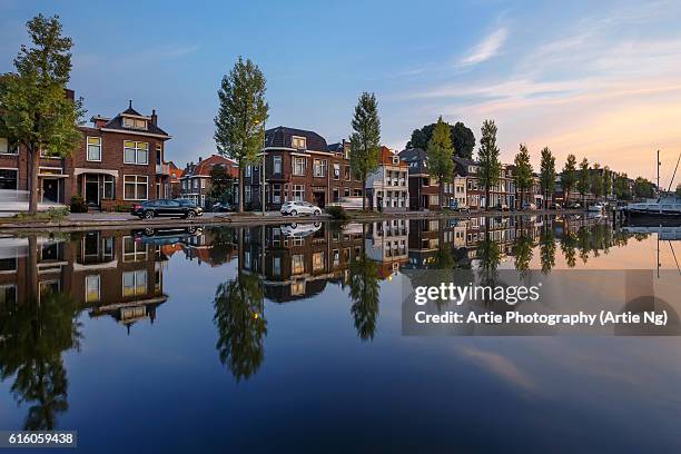 sunrise along the kattensingel canal, gouda, south holland, netherlands - gouda stock pictures, royalty-free photos & images