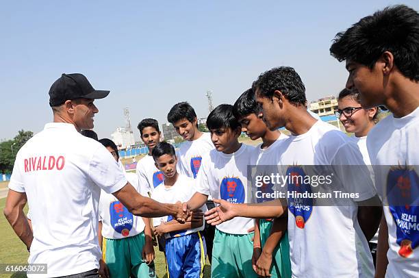 Brazilian former footballer Rivaldo interacting with young footballers, on October 21, 2016 in Greater Noida, India.