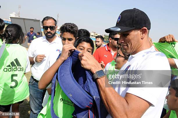 Brazilian former footballer Rivaldo interacting with young footballers, on October 21, 2016 in Greater Noida, India.