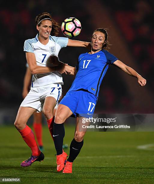 Gaetane Thiney of France battles with Jill Scott of England during the International Friendly between England and France at Keepmoat Stadium on...