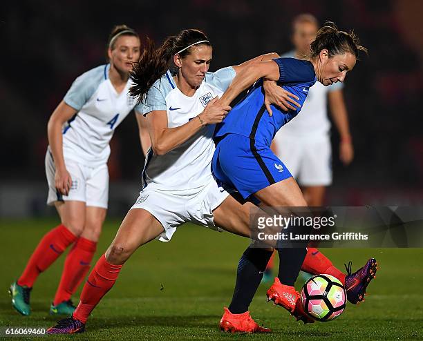 Gaetane Thiney of France battles with Jill Scott of England during the International Friendly between England and France at Keepmoat Stadium on...