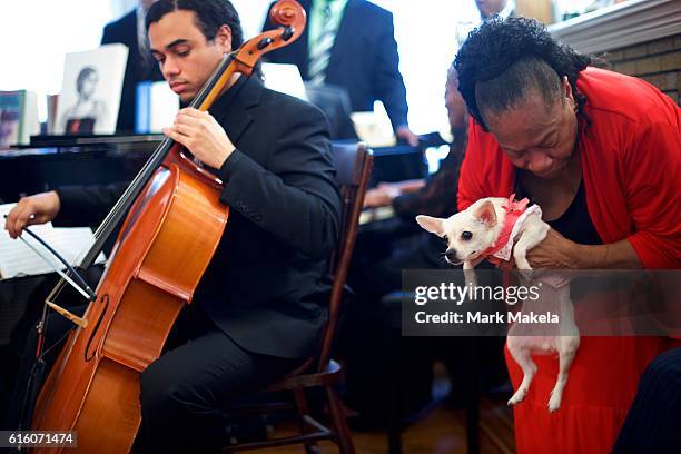 Pat Jackson holds "Lady," the mascot of the Marian Anderson Residence Museum, before Treasury Secretary Jacob Lew visited to discuss her inclusion on...