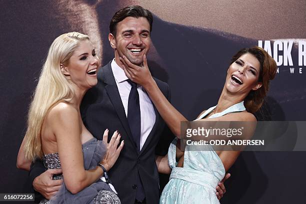 German model Micaela Schaefer , her boyfriend Felix Steiner and model Mandy Lange pose on the red carpet ahead of the premiere of the film "Jack...