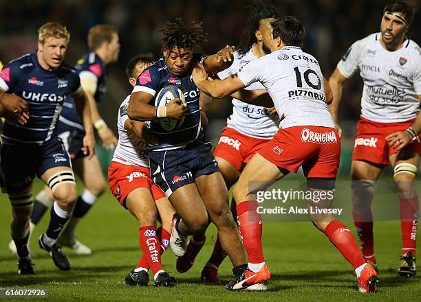 Paolo Odogwu of Sale Sharks is tackled by Francois Trinh-Duc of RC Toulon during the European Rugby Champions Cup match between Sale Sharks and RC...
