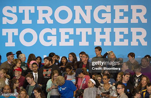 Attendees wait for the start of a campaign rally with Hillary Clinton, 2016 Democratic presidential nominee, in Cleveland, Ohio, U.S., on Friday,...
