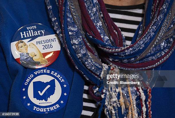 Attendees wear buttons in support of Hillary Clinton, 2016 Democratic presidential nominee, during a campaign event in Cleveland, Ohio, U.S., on...