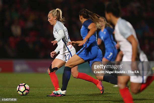 Toni Duggan of England runs past Delphine Cascarino of France during the Women's International Friendly match between England and France at Keepmoat...